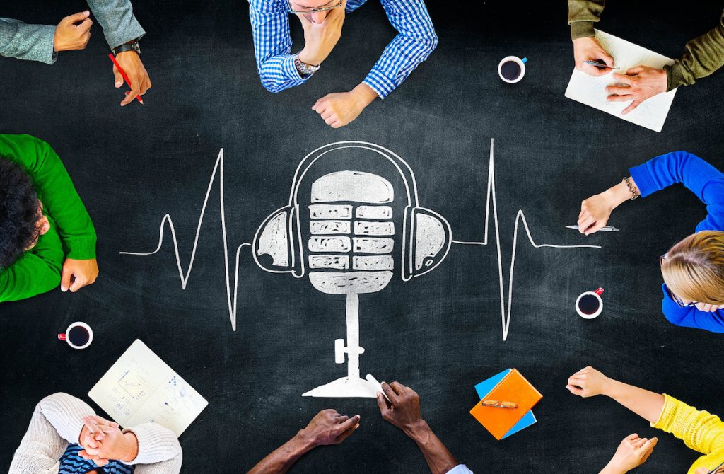 image of a group of people sitting around a table with a microphone drawn in chalk on the table